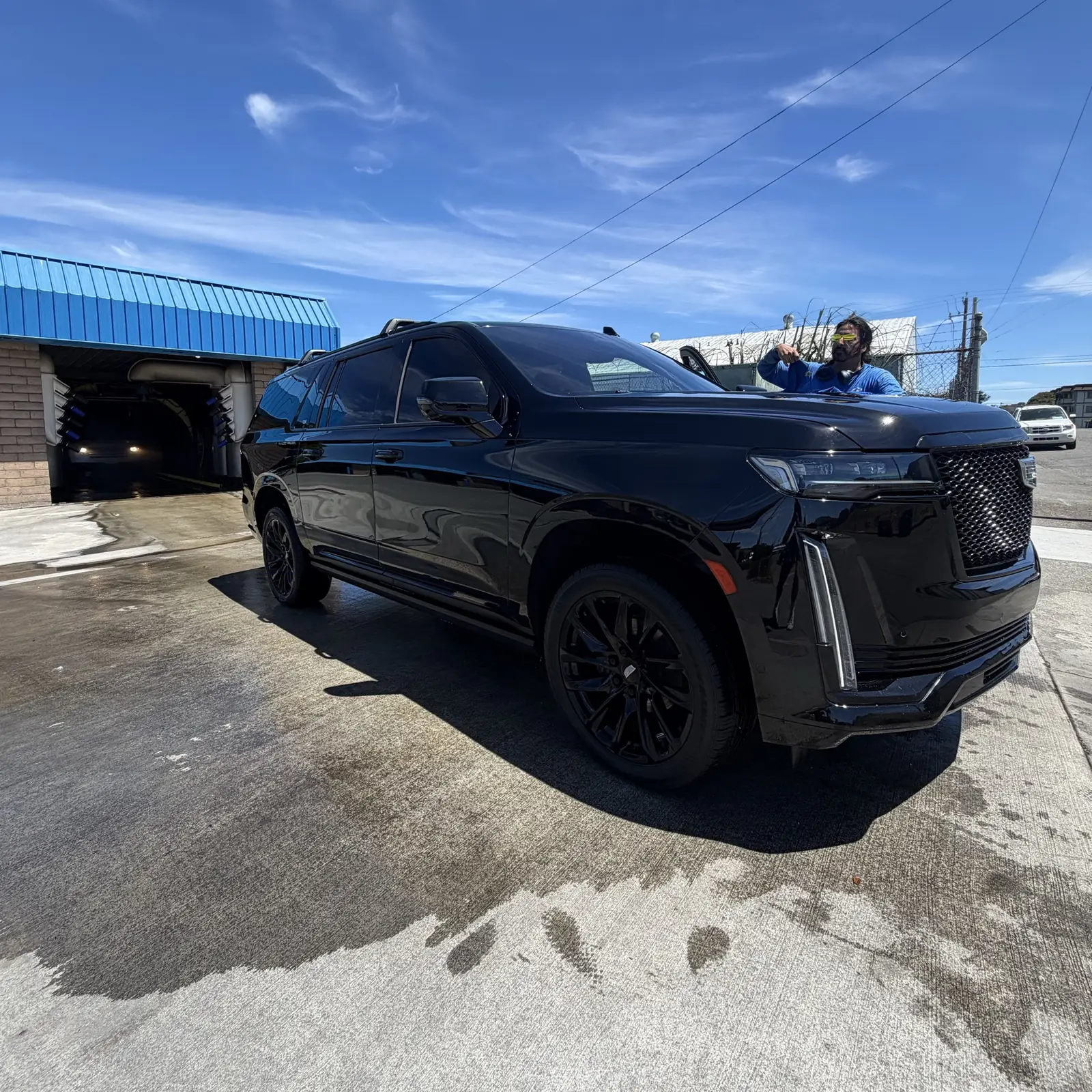 A black Cadillac Escalade, washed and dried, on the Zenith Car Wash lot
